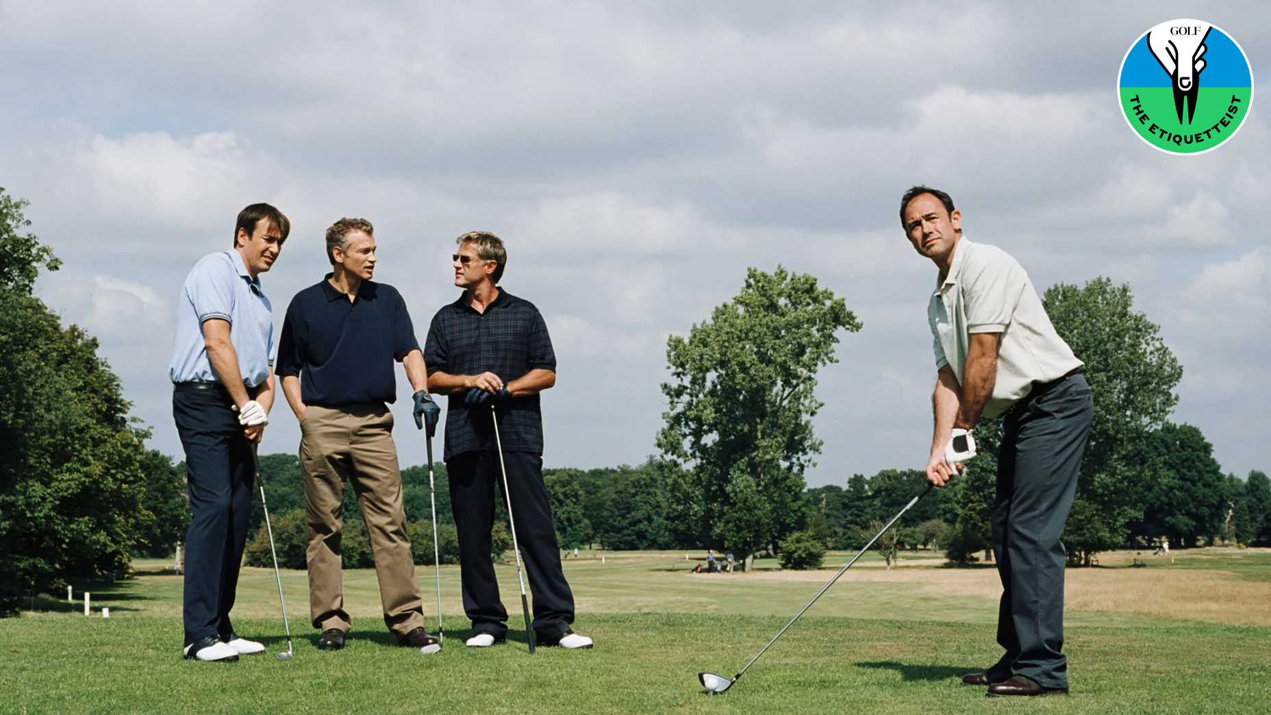 Four golfers getting ready to tee off